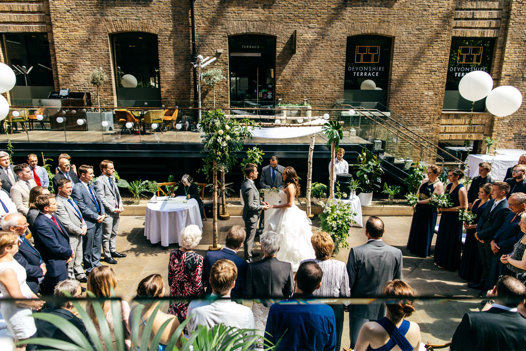wedding-vows-surrounded-by-guests-devonshire-terrace-wedding