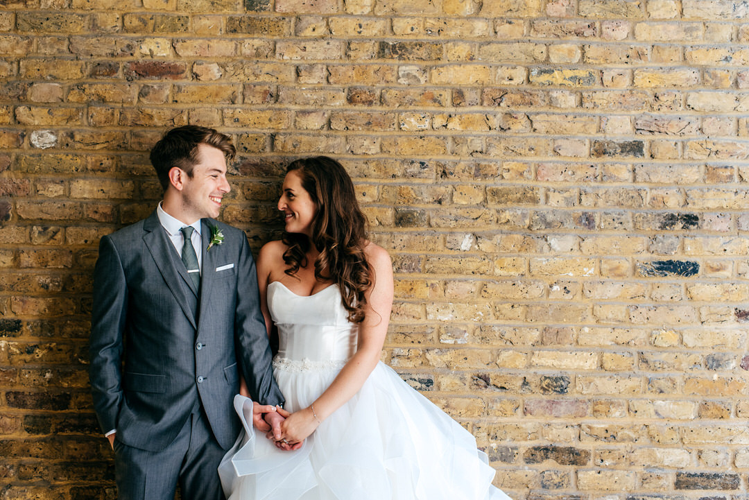 wedding-portraits-couple-laughing-together-urban-backdrop-london-wedding-photographer