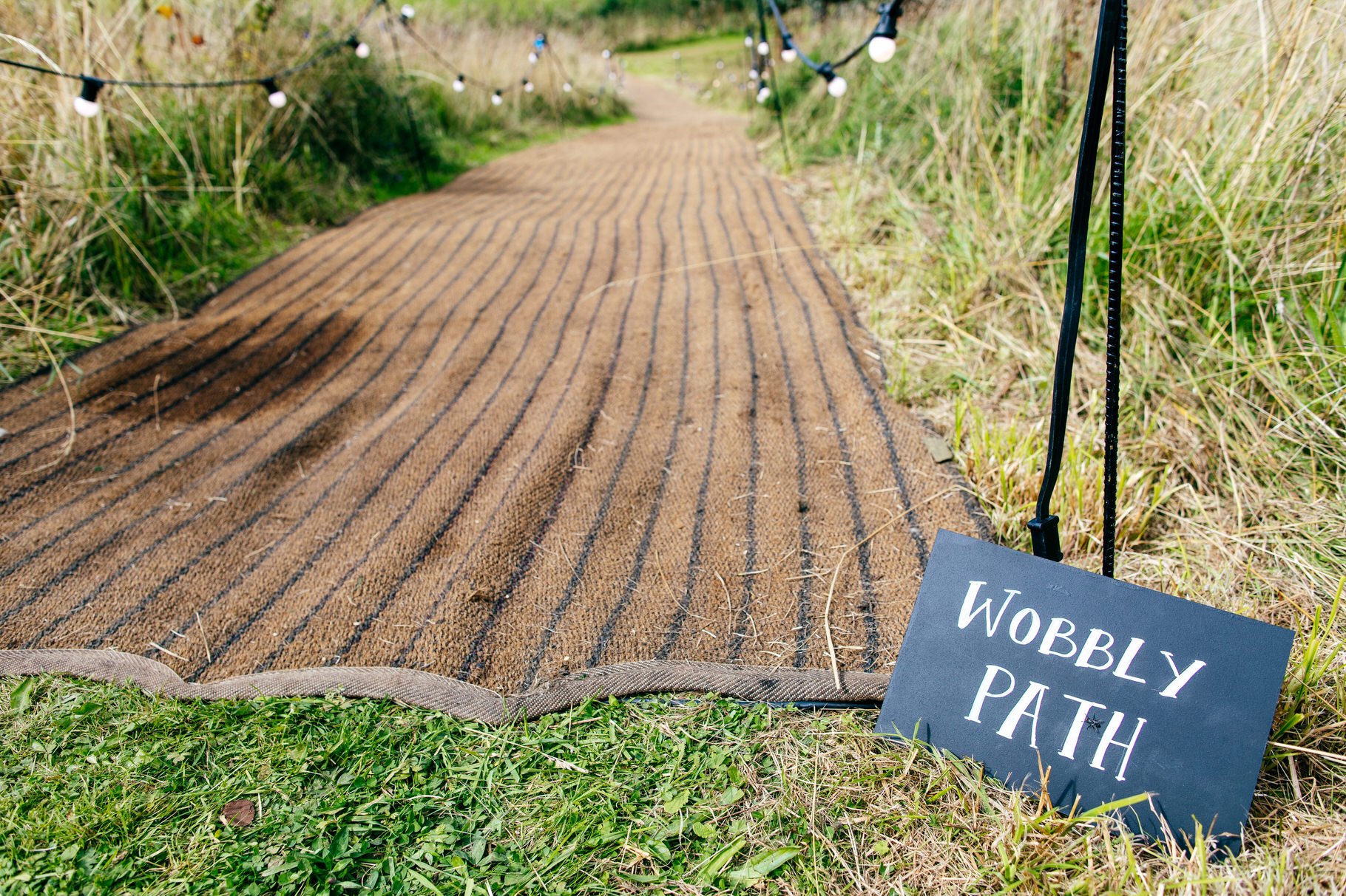 wobbly path with festoon lighting at back garden wedding 