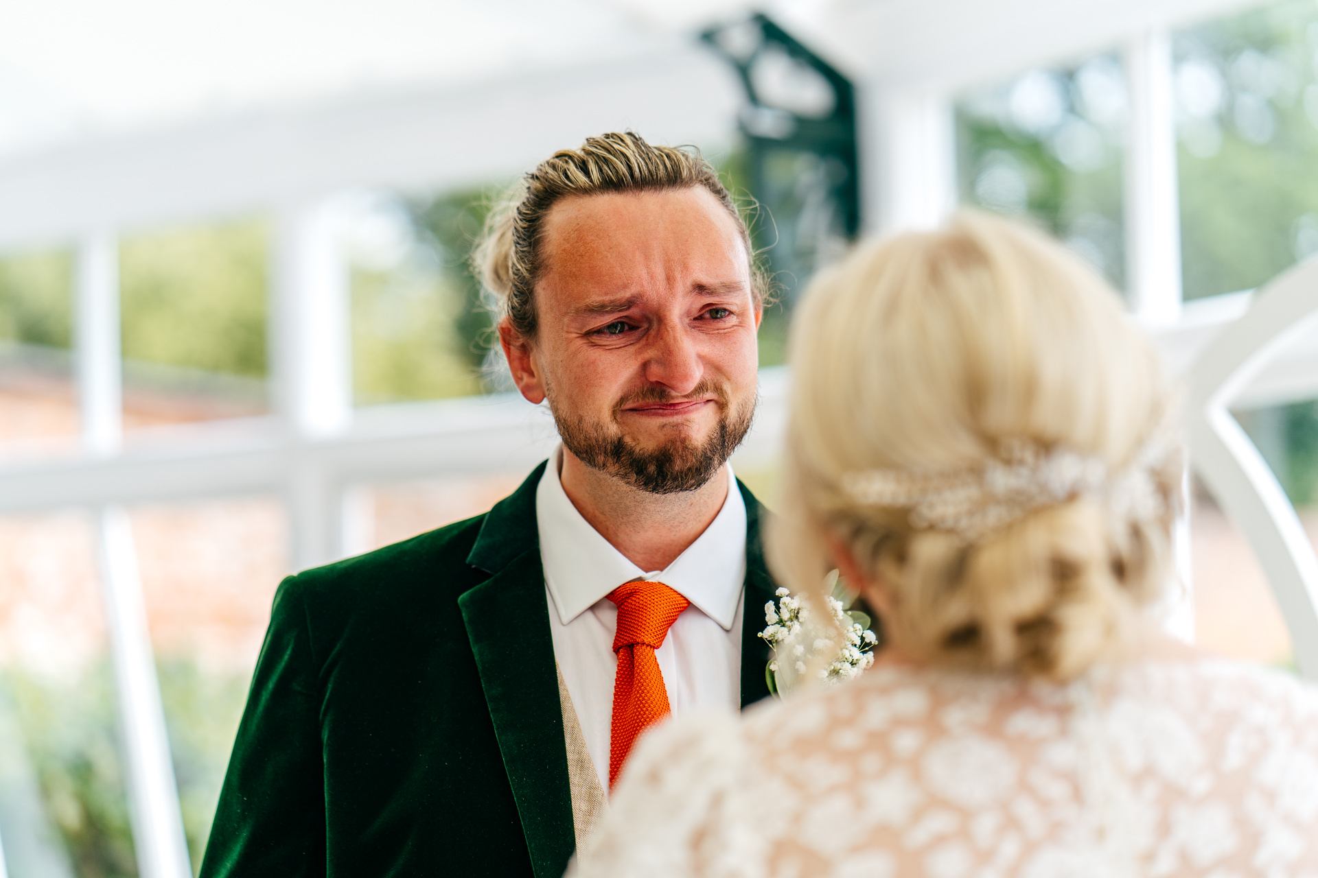Super emotional groom during ceremony in the glasshouse at Combermere Abbey Wedding
